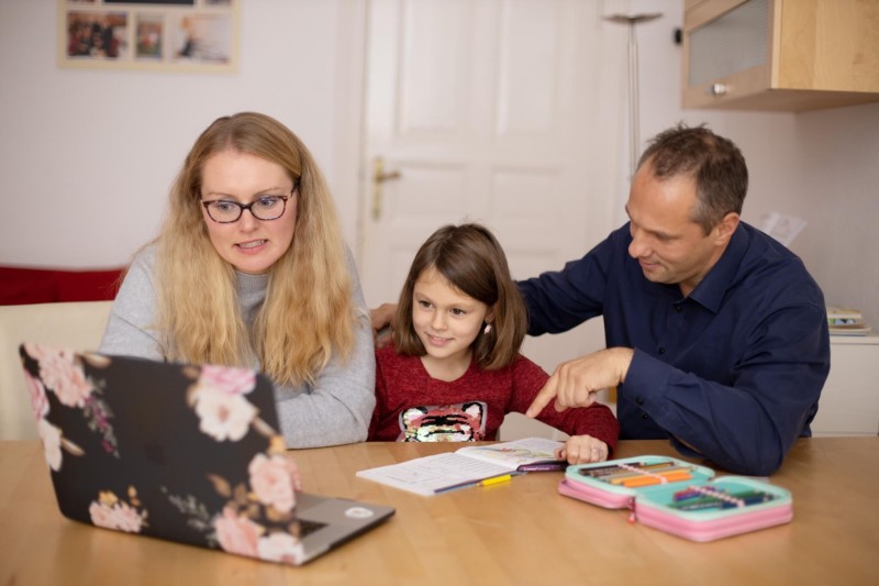 A family working together at a table during an online learning moment